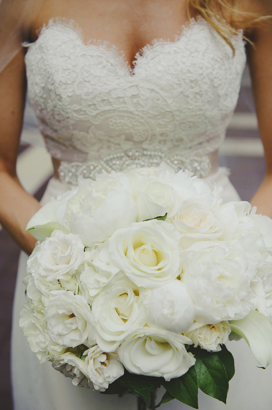 Stunning all white bridal bouquet with roses and trumpet lilies by Yellow Canary Floral & Event Design