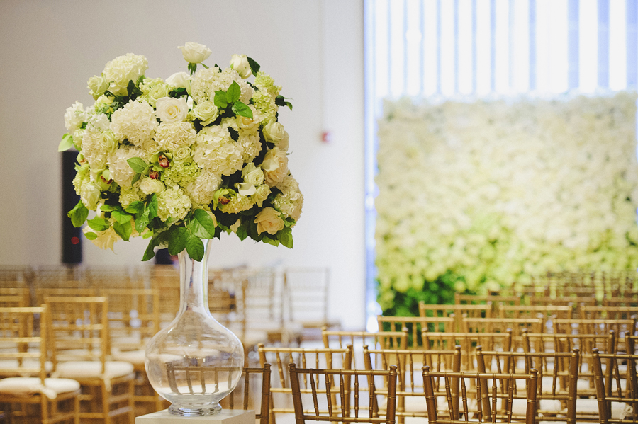 White and green focal arrangement and flower wall for wedding ceremony by Yellow Canary Floral & Event Design located in Cincinnati, OH. www.yellowcanaryonline.com