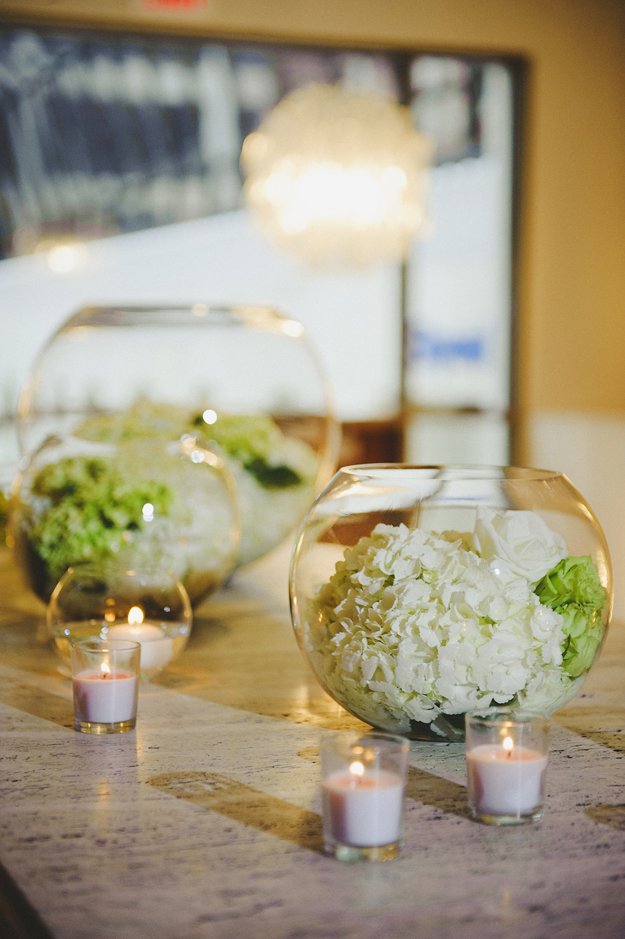 White floral filled glass globes for white and green wedding by Yellow Canary Floral & Event Design