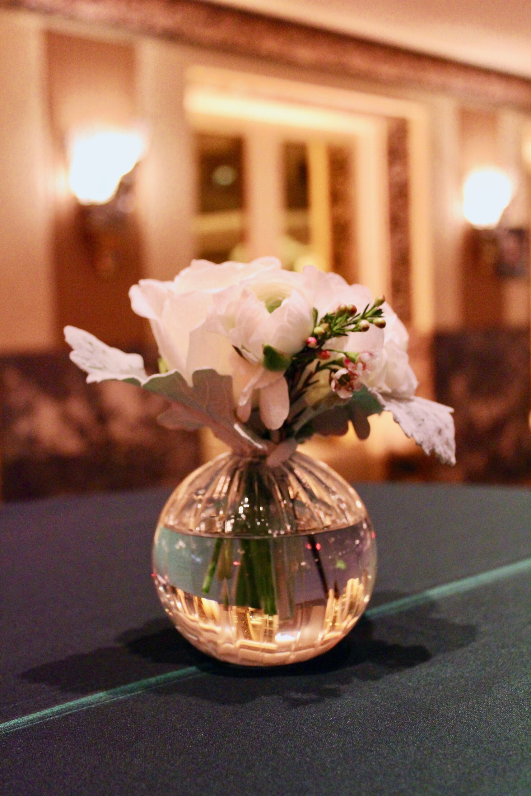 Meredith &amp; Elliot’s guests enjoyed a gorgeous reception in a room full of tall, focal arrangements full of white flowers and an assortment of greenery including eucalyptus and silvery lamb’s ear.