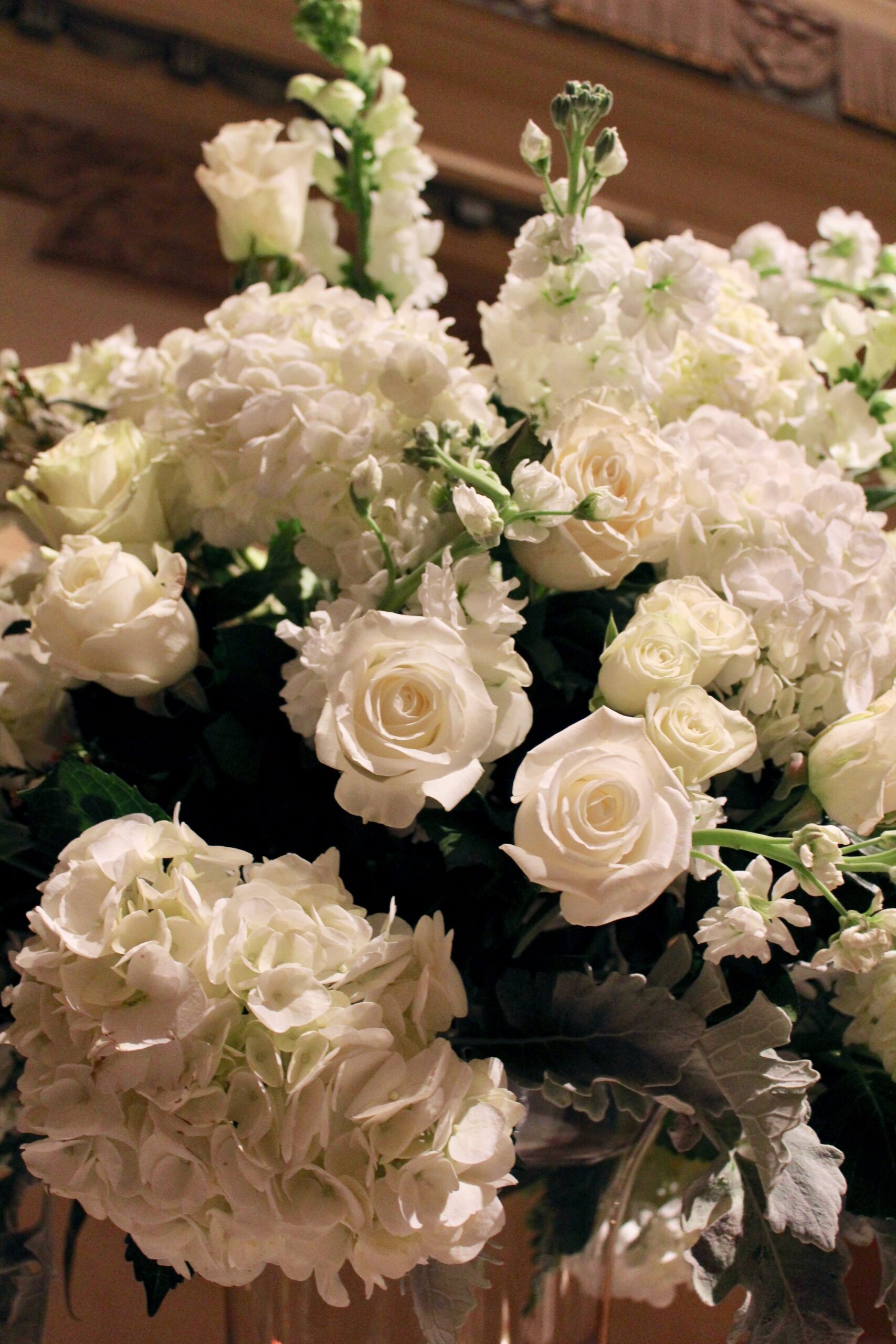 Meredith &amp; Elliot’s guests enjoyed a gorgeous reception in a room full of tall, focal arrangements full of white flowers and an assortment of greenery including eucalyptus and silvery lamb’s ear.