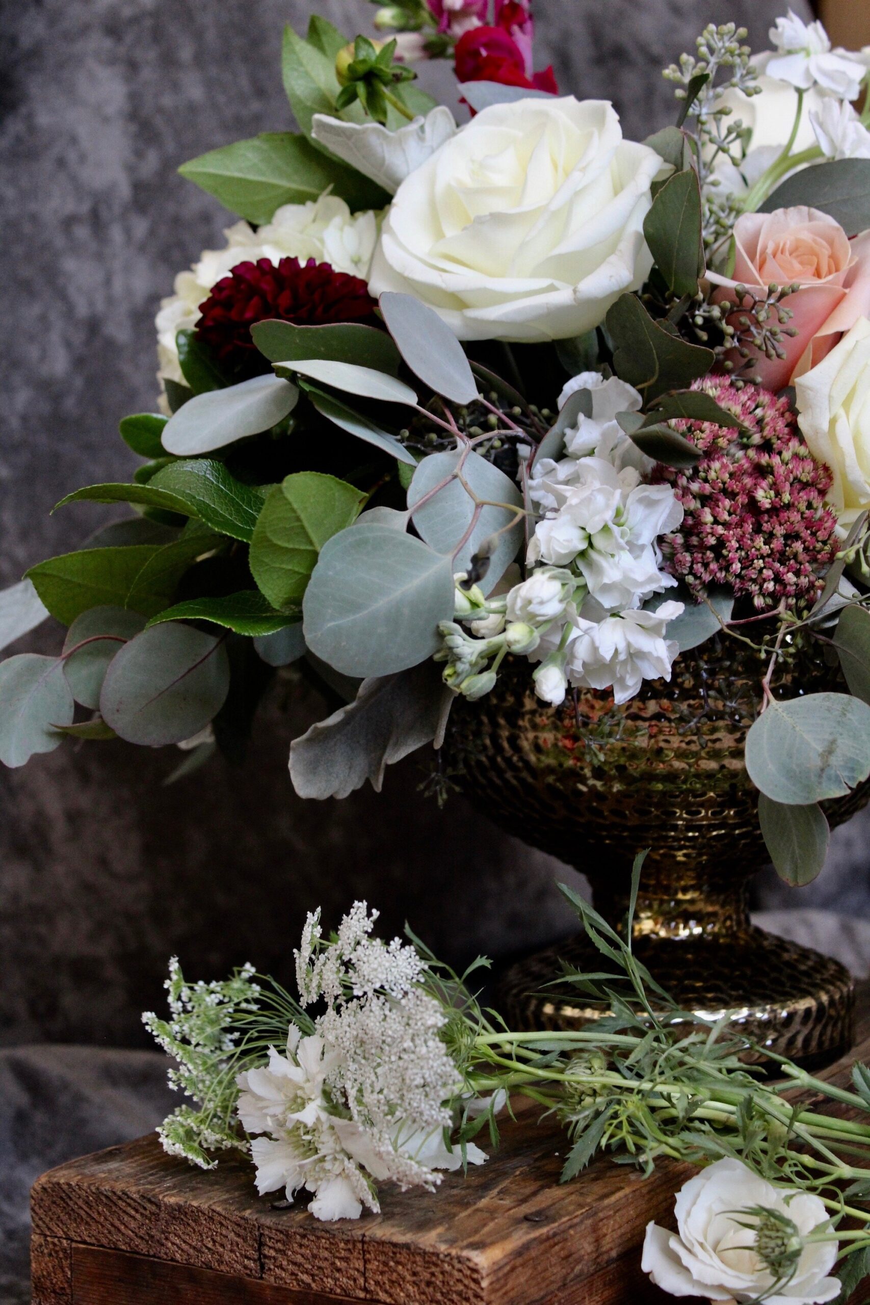 Yellow Canary Floral &amp; Design Studio wedding floral arrangement with white and blush roses and wildflowers.