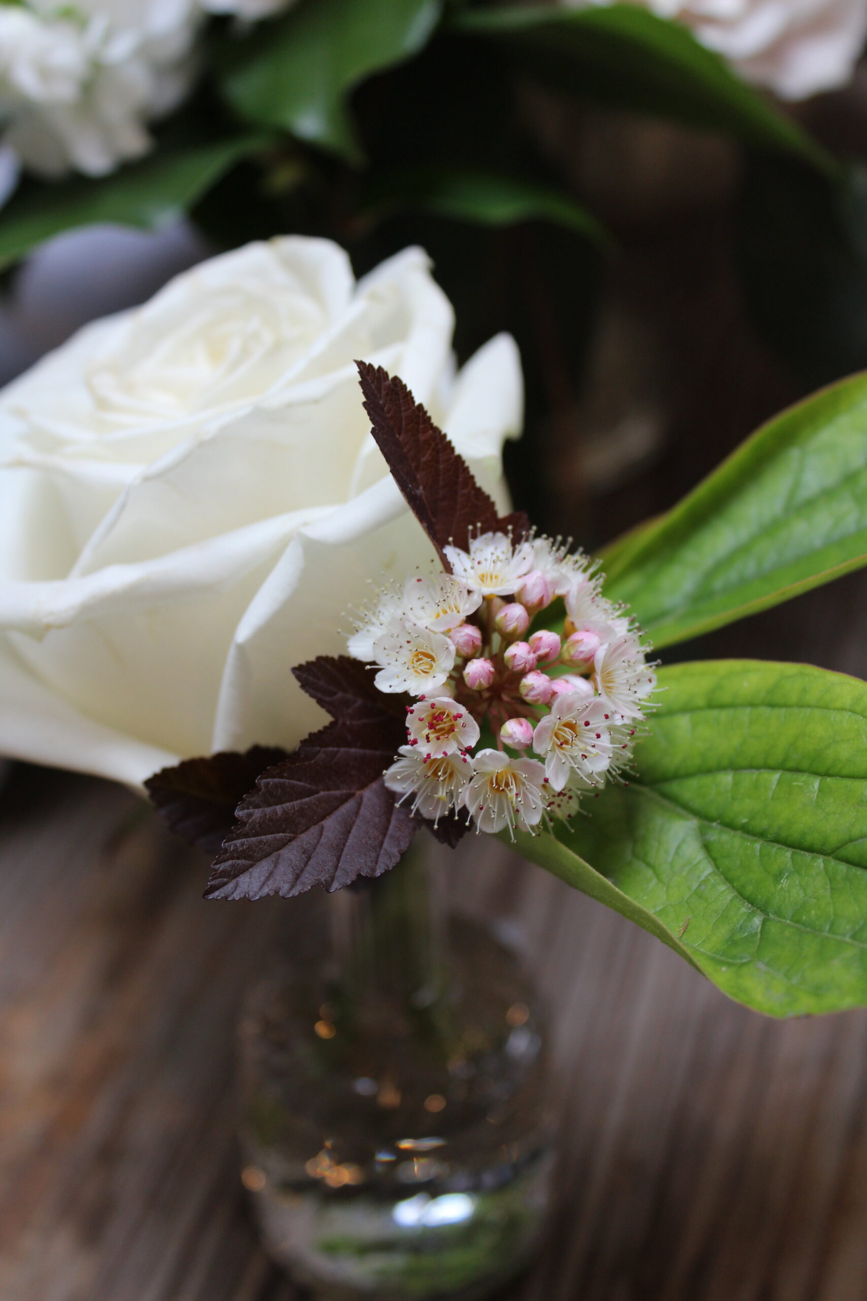 Yellow Canary Floral &amp; Design Studio wedding floral arrangement with white and blush roses and wildflowers.