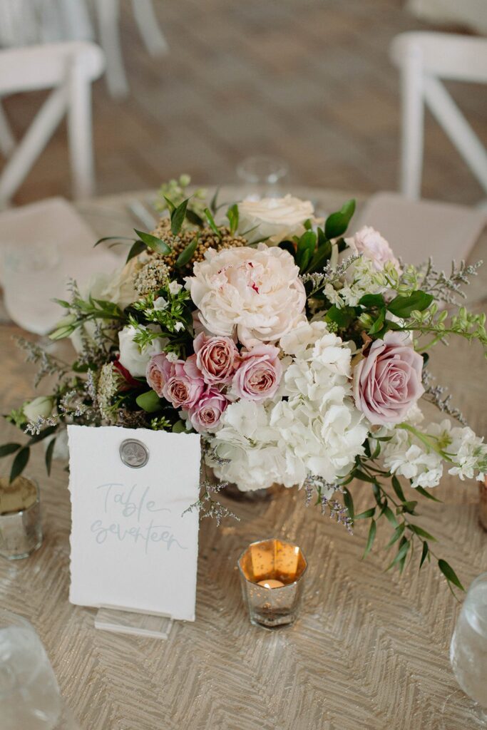 floral centerpieces in blush, white, and green for wedding at Greenacres