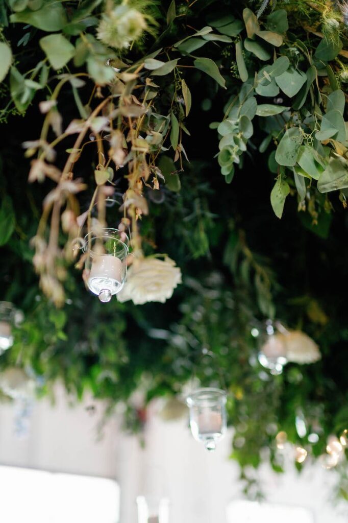 Hanging florals over head table at wedding